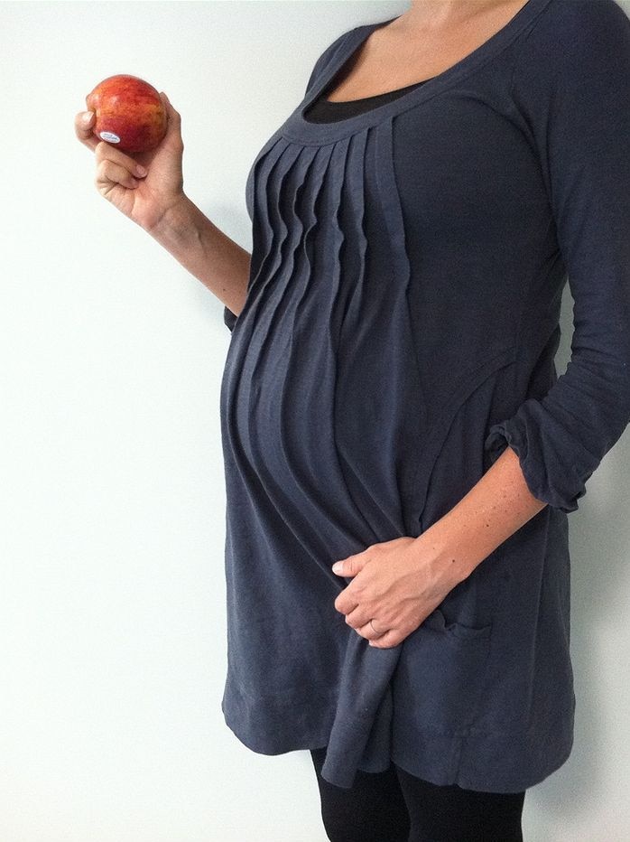 Pregnant woman with an apple in her hand