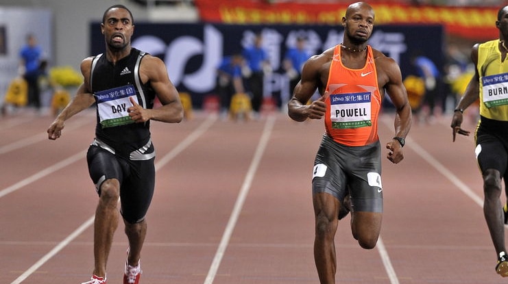 Tyson Gay (L) crosses the line ahead of Jamaican Asafa Powell (C) in the 100m in Shanghai in 2009.
