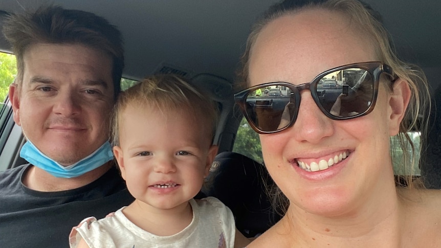 Selfie photo of Kyron and Nicola Miethke, with two-year-old daughter Freya in a car.