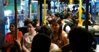 People crowd on a bus in Bondi.