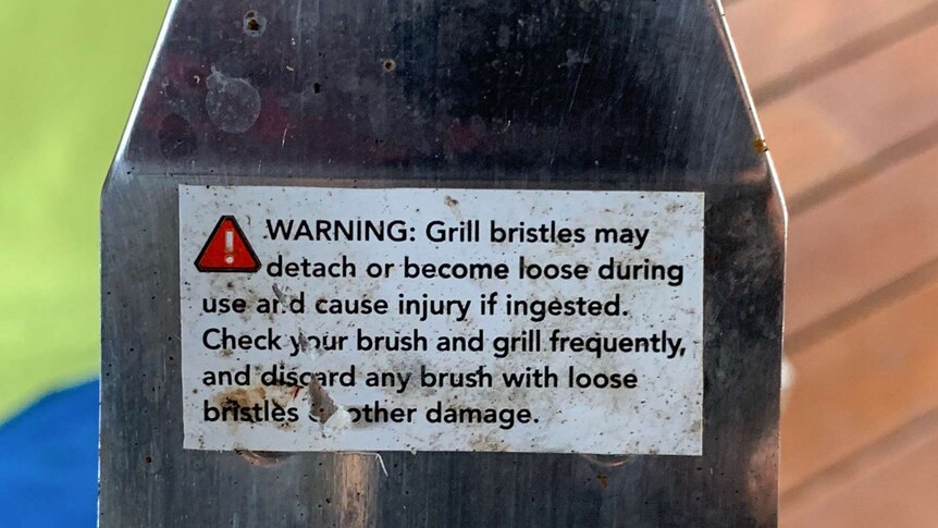 Warning on a wire brush.