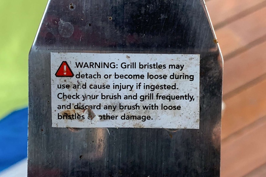 Warning on a wire brush.
