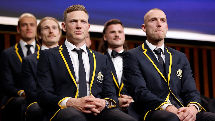 James Sicily and Callum Wilkie sit in their All-Australian blazers at the AFL Awards night.
