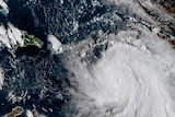 NASA satellite image of Hurricane Maria. It is a big white storm system.