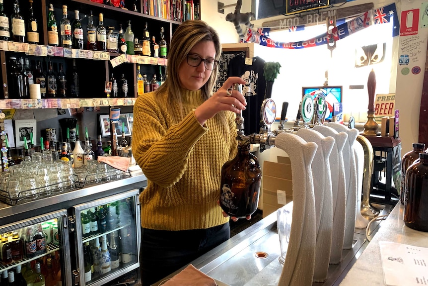 Melbourne publican Jess McGrath pouring a beer at the Palace Hotel.