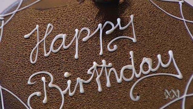 Birthday cake with icing writing "Happy Birthday"