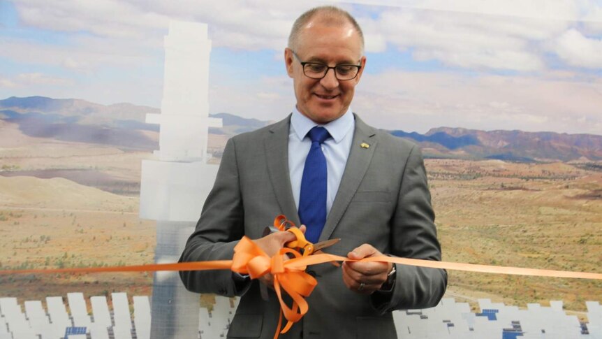 Premier Jay Weatherill cuts a ribbon with scissors.