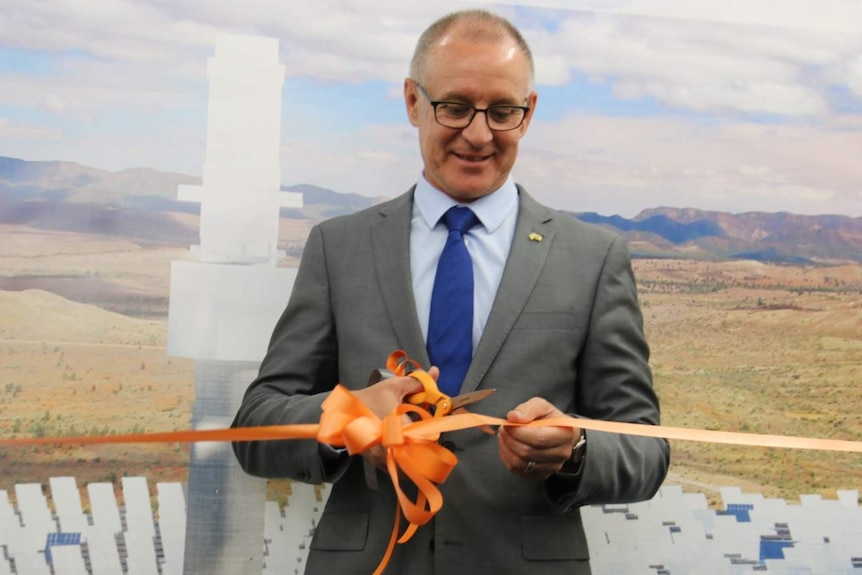 Premier Jay Weatherill cuts a ribbon with scissors.