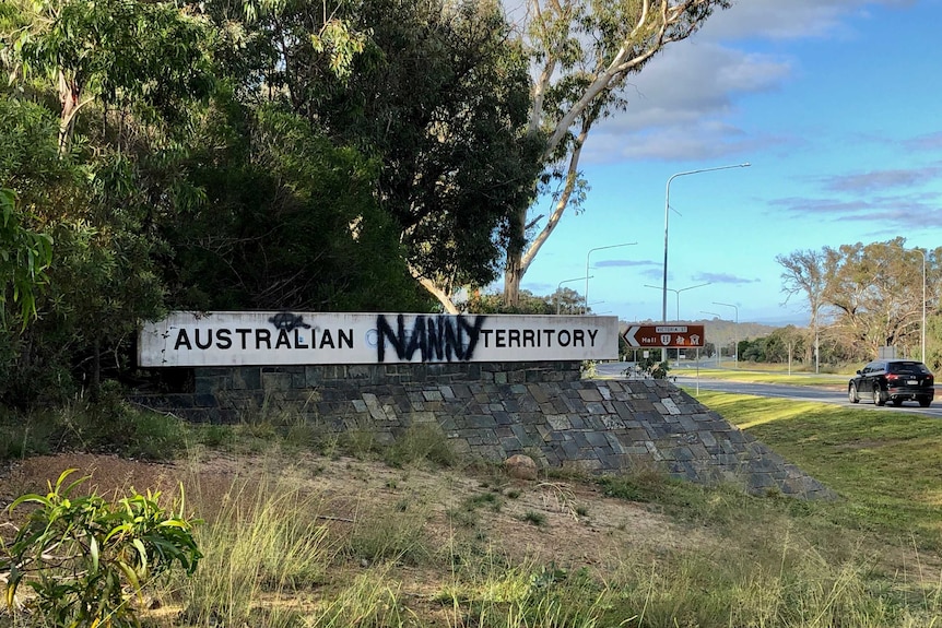 The sign to the ACT border is sprayed with graffiti, and now reads Australian Nanny Territory.