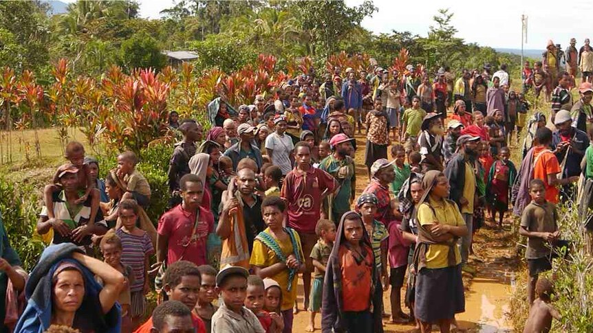 Papua New Guineans waiting for aid at an airport