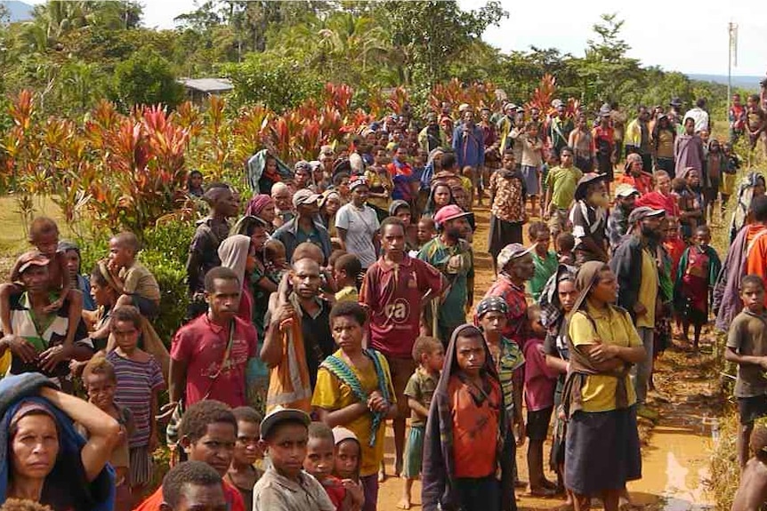 Papua New Guineans waiting for aid at an airport