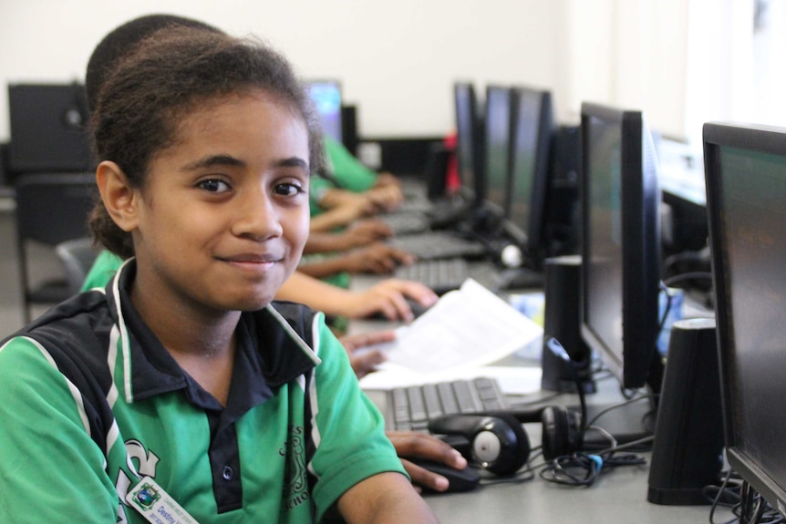 Primary school student, Destiny, smiling, sitting in front of a computer