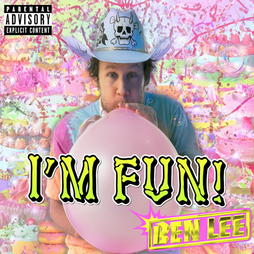 ben lee blows up a balloon wearing a cowboy hat with a skull on it wearing a tie-dye shirt