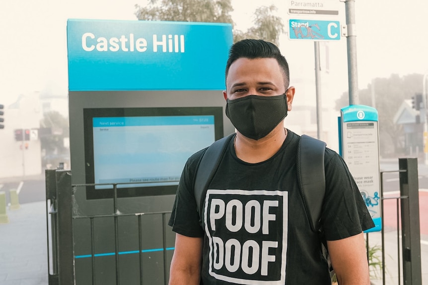 A man standing at a bus stop 