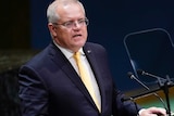 Scott Morrison speaks while standing at a lectern.
