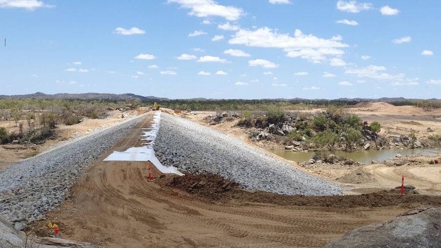 Millions of cubic metres of soil and rock form the basis of a multi-million dollar dam wall on a river in Etheridge Shire.