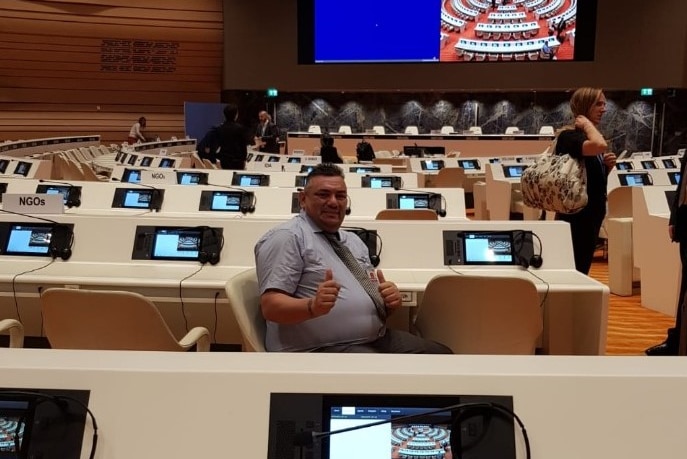 A man giving the thumbs up in the UN building