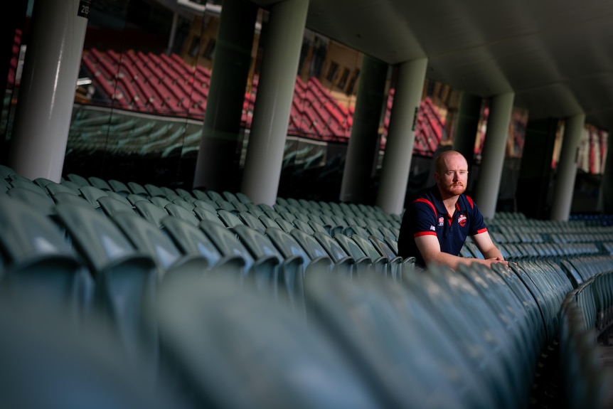 Spinner Lloyd Pope sits in the stands at the Adelaide Oval