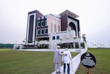 Two elderly men approach a mosque in Singapore