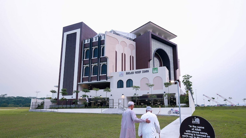 Two elderly men approach a mosque in Singapore