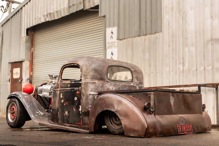 A hot rod pick-up truck that has been damaged by fire.