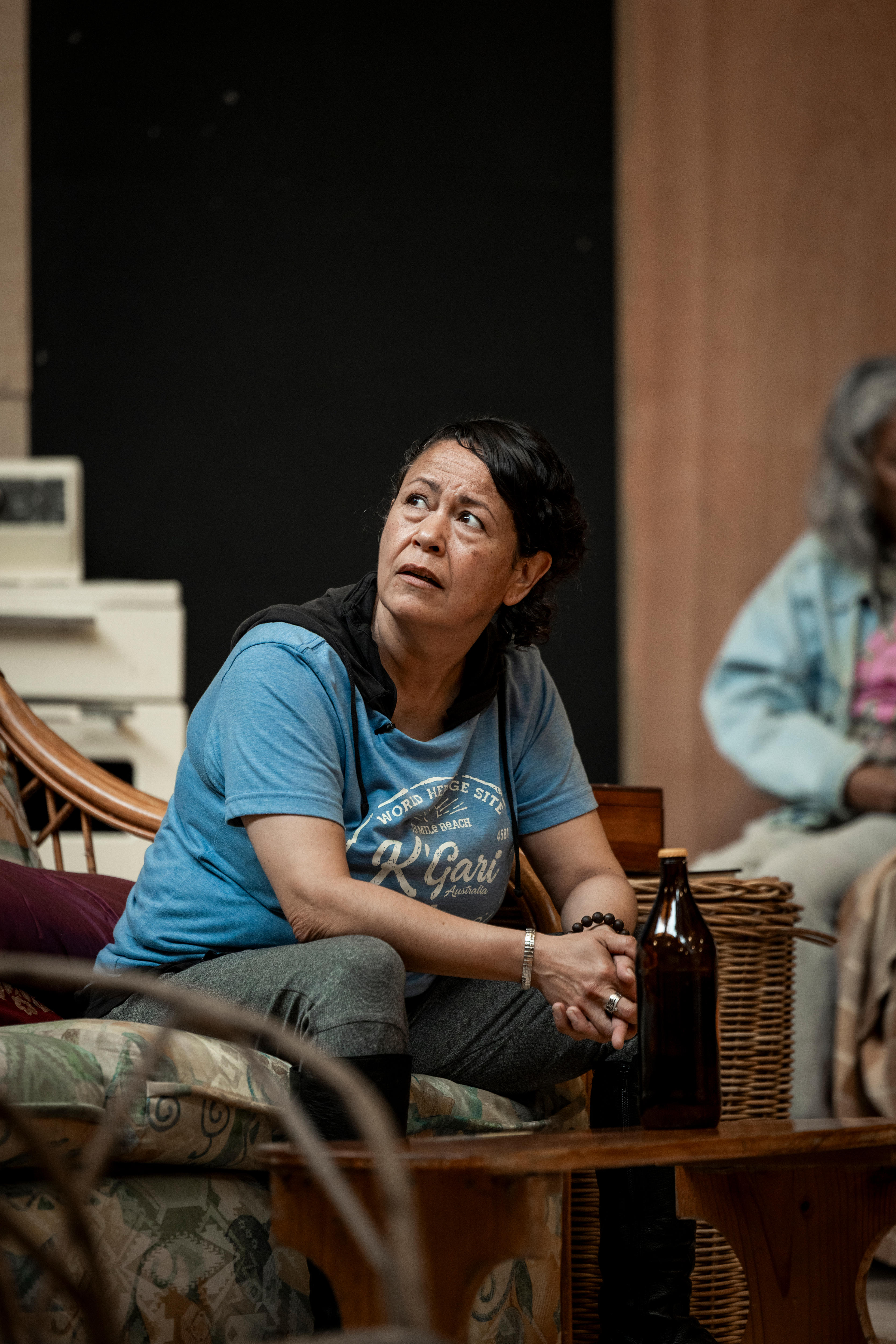 An actor stares up plaintively during a rehearsal.