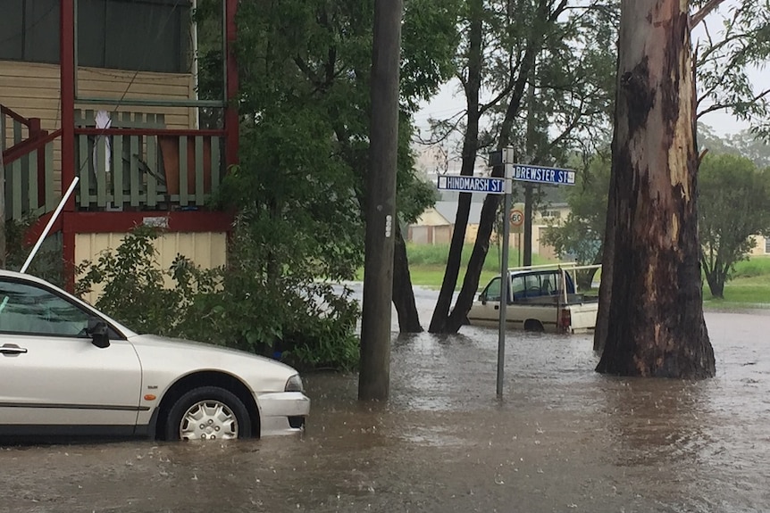 A suburban street corner flooded