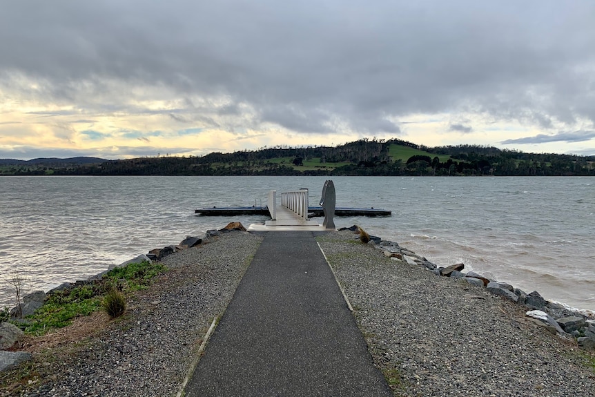 A pontoon with rolling hills in the background. 