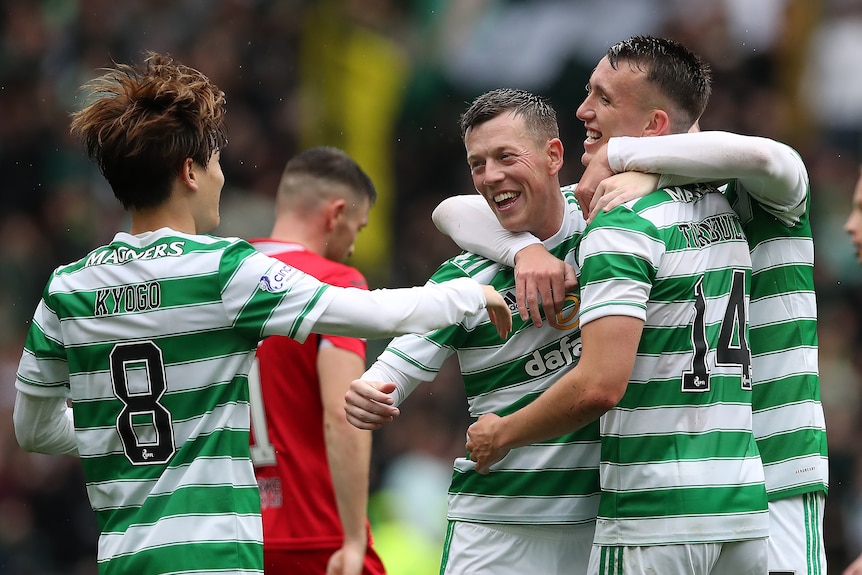 Celtic players wearing green and white hoops celebrate