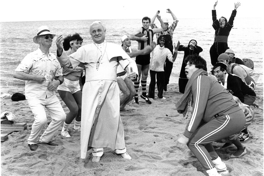 Max as pope on beach