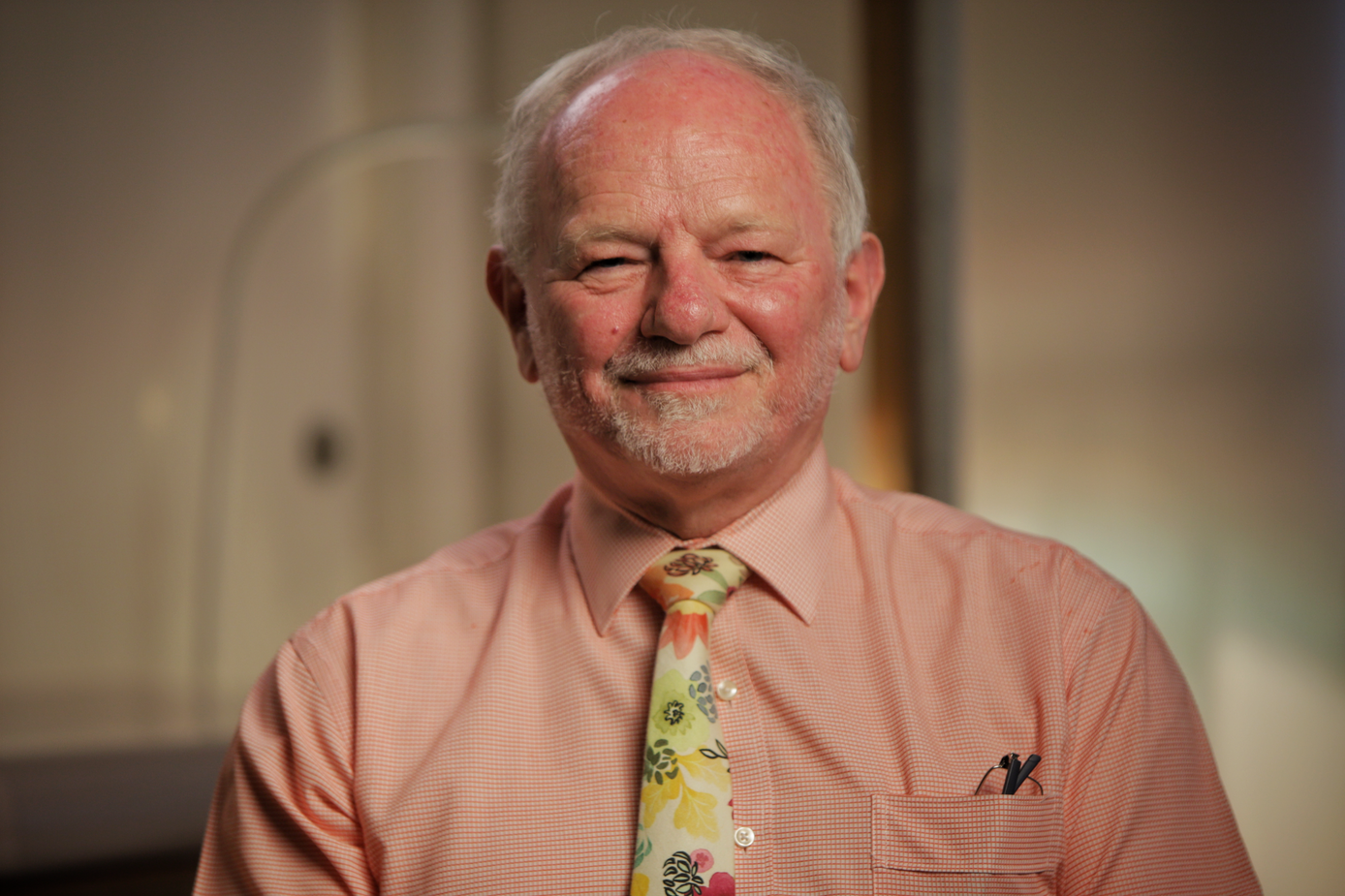 Man wearing a light pink shirt and tie.