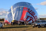 Hot air balloon sinks onto ground as crowd gathers to see Fedor Konyukhov