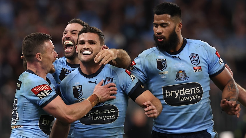 Nathan Cleary is hugged by his teammates