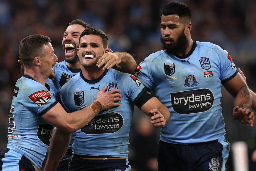 Nathan Cleary is hugged by his teammates