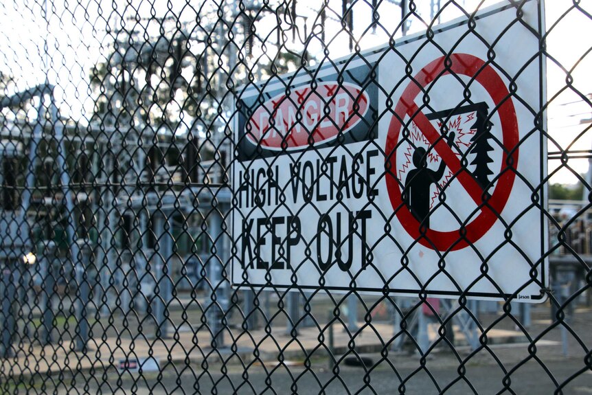 A sign at a power station saying high voltage keep out.
