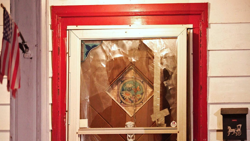 The smashed front door of the house where Amanda Berry, Gina DeJesus and Michele Knight were found in Cleveland, Ohio.