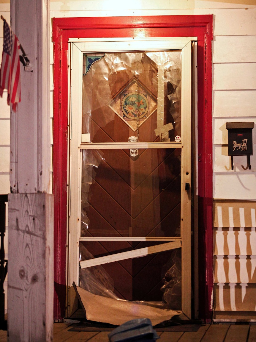 The smashed front door of the house where Amanda Berry, Gina DeJesus and Michele Knight were found in Cleveland, Ohio.
