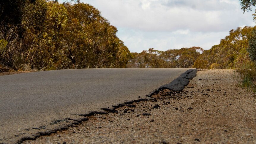 A close up of cracked bitumen on the unsealed shoulder of the Robinvale-Sea Lake road.