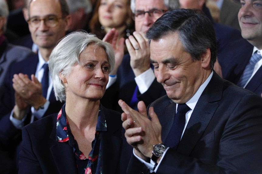 Conservative presidential candidate Francois Fillon applauds while his wife Penelope looks on, January 29 2017.