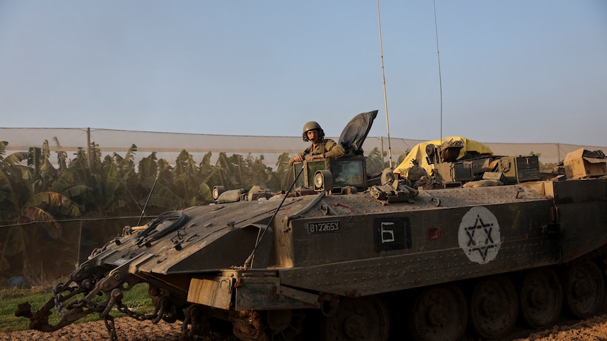 An Israeli soldier rides in an armoured personnel carrier in Gaza.