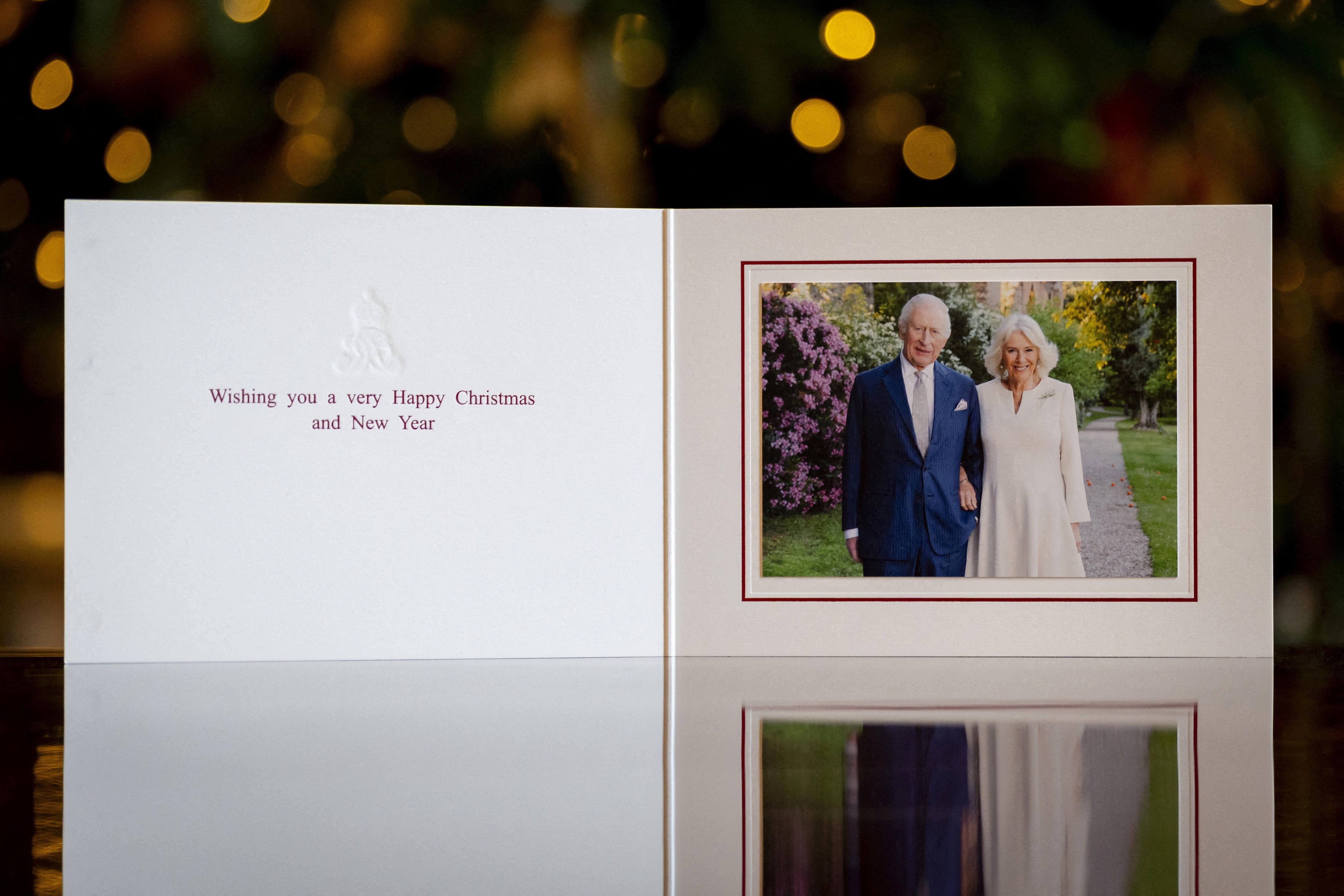 A Christmas Card featuring a photo of the King and Queen that says wishing you a very happy christmas and new year