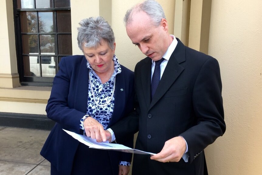 AMA president Janice Fletcher and Salaried Medical Officers official David Pope look at documents