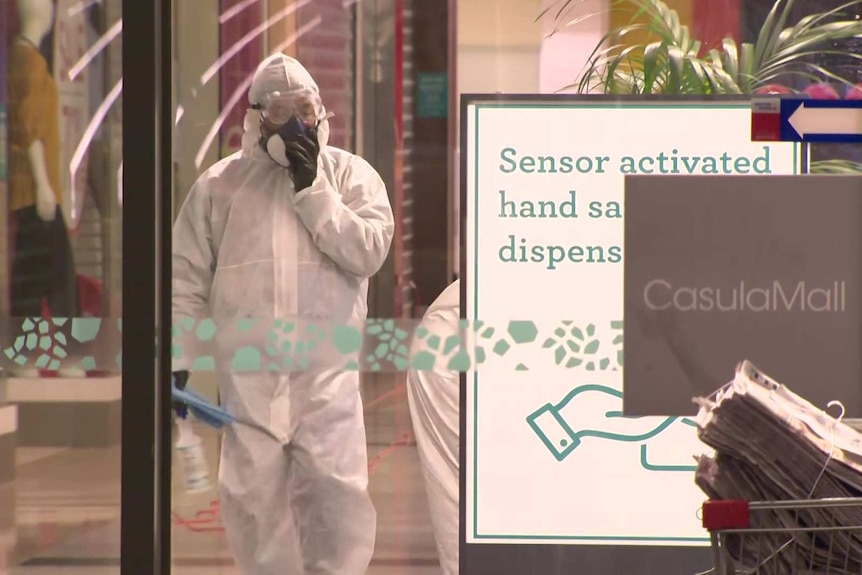 hazmat suited people clean casula mall