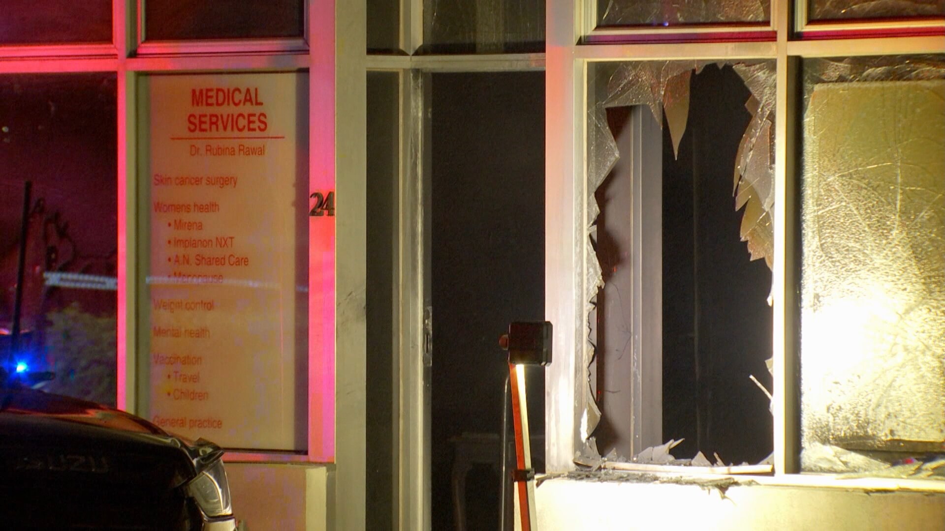 A smashed window of a fire damaged medical centre.