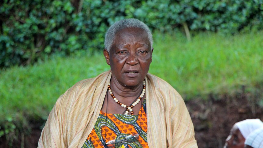 An elderly woman dressed in vibrant african cloths