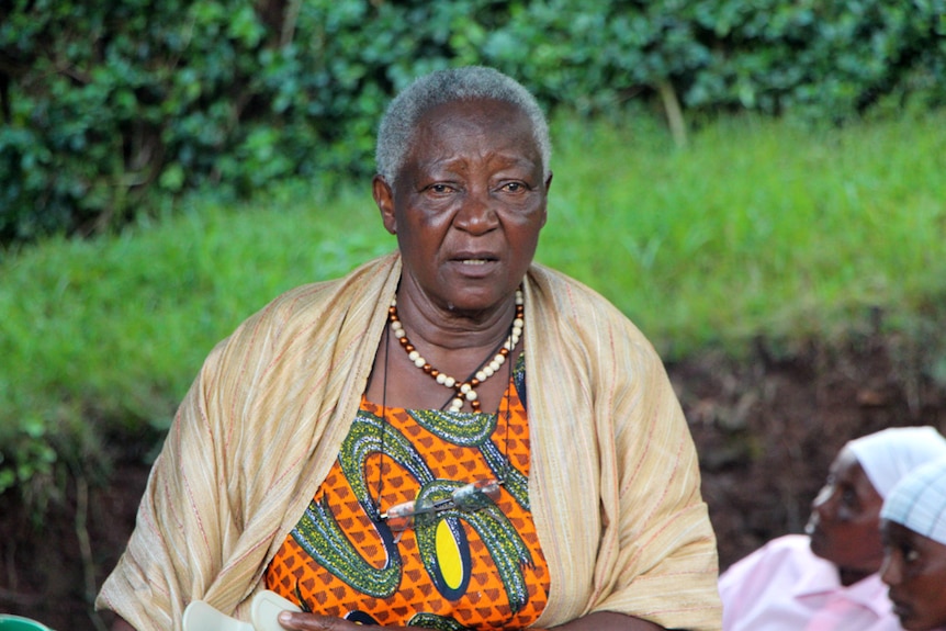 An elderly woman dressed in vibrant african cloths