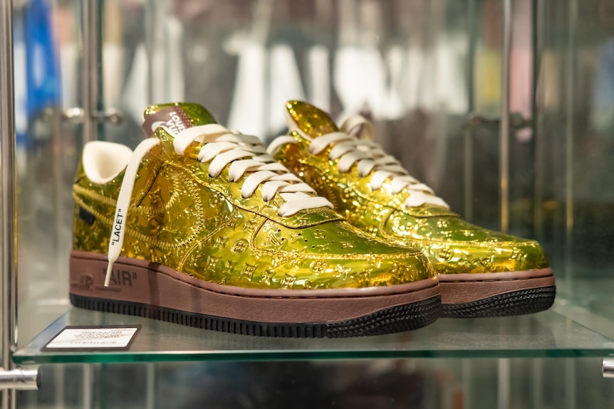 A gold louis vuitton nikes worth 9 thousand dollars.