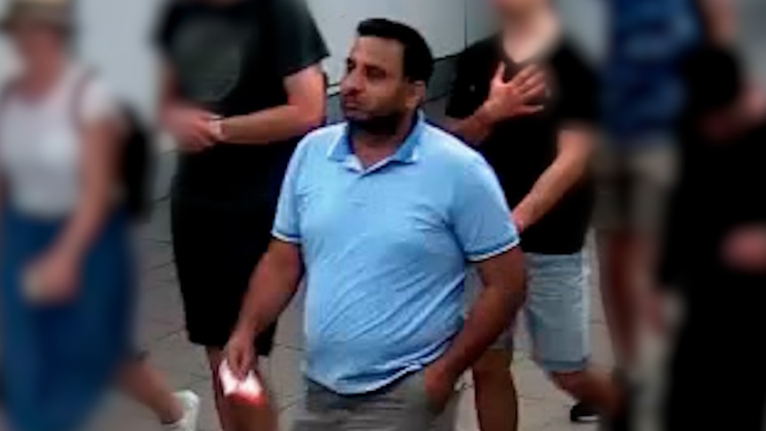 Man walking through airport terminal 