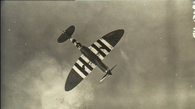 A Spitfire with D-Day recognition markings