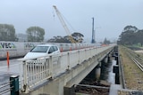 View of car travelling across a bridge.